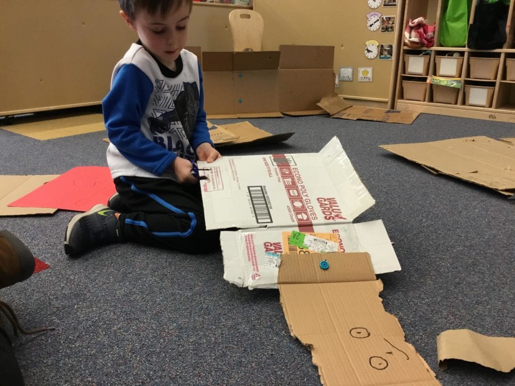 Boy building with cardboard