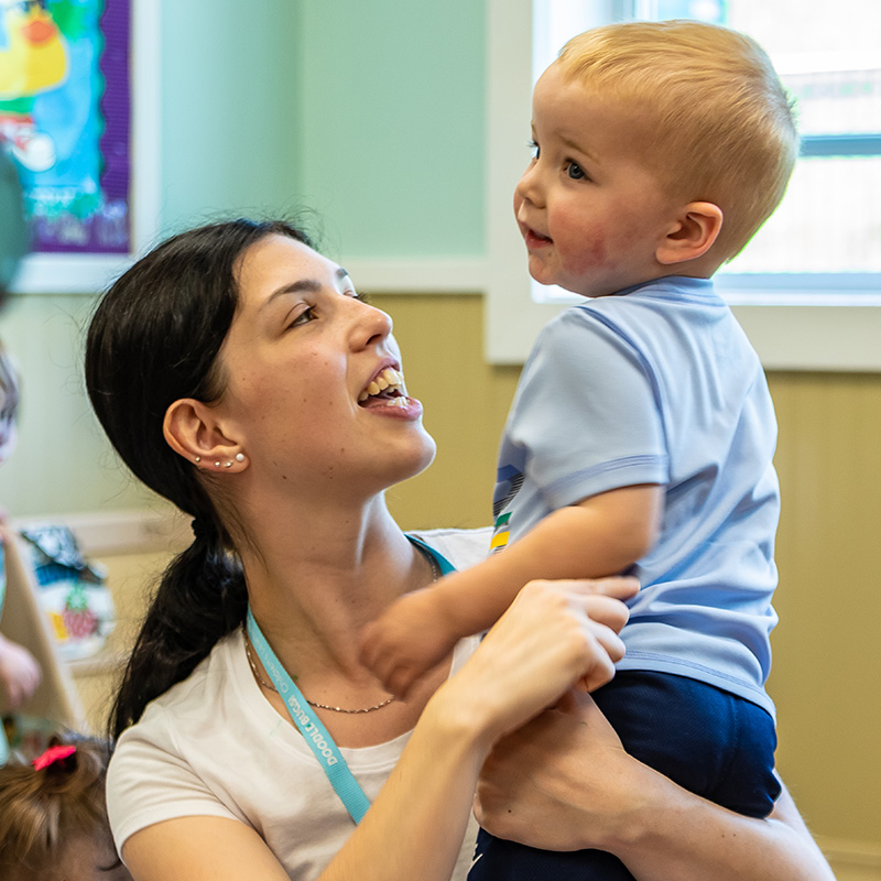 Teacher holding a toddler
