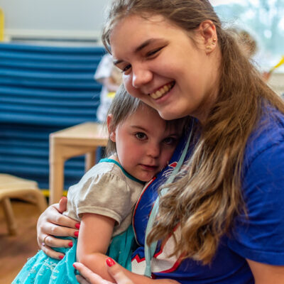 Teacher hugging a toddler