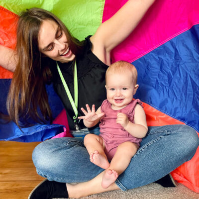 Teacher with infant in their lap